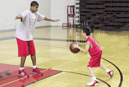Edgar Sosa challenges the observer's grandson, Koby Springer, during a Rick Pitino summer camp in 2006.