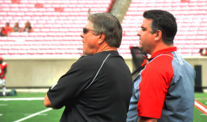 Tom Jurich and Rocco Gasparo watch the action.