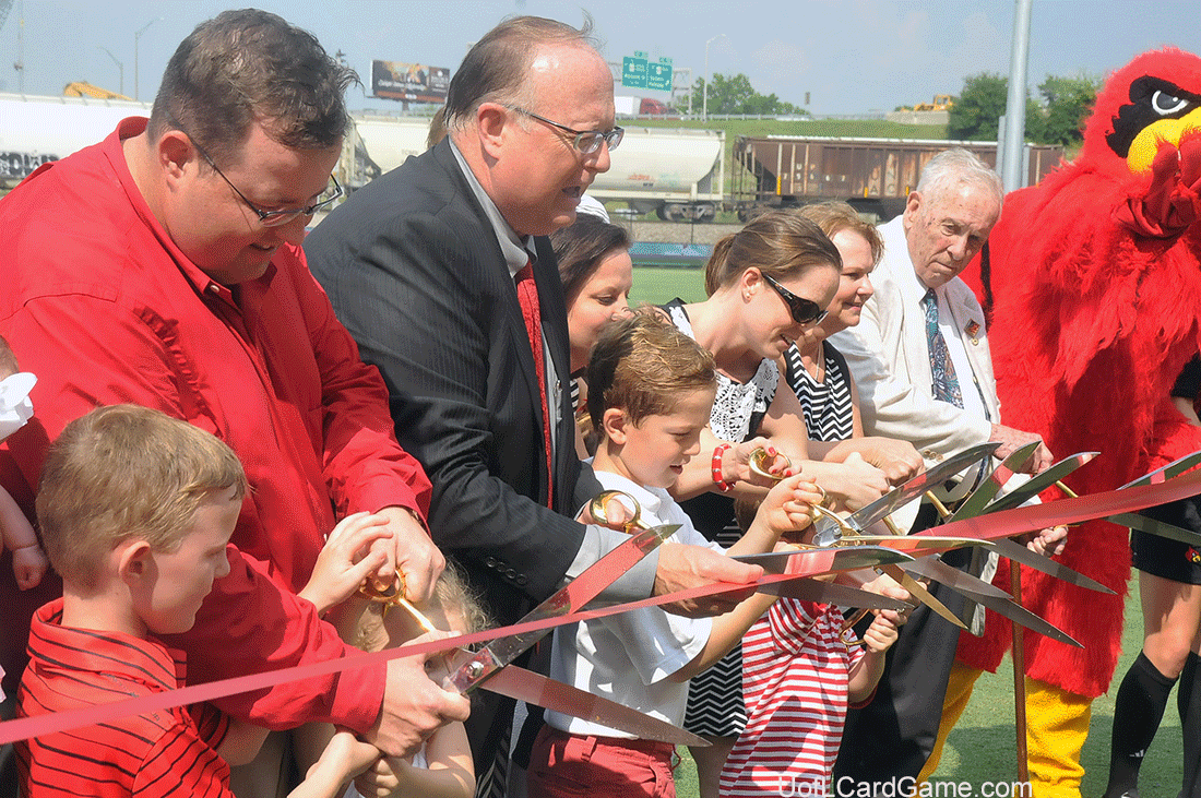 Mark Lynn (in dark suit) and family cut the ribbon. Twenty-one family members participated.