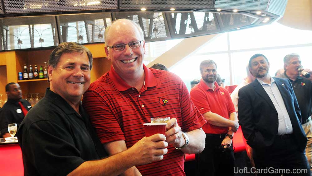 Tom Jurich and Kenny Klein raise a toast to their working relationship and friendship at the University of Louisville.