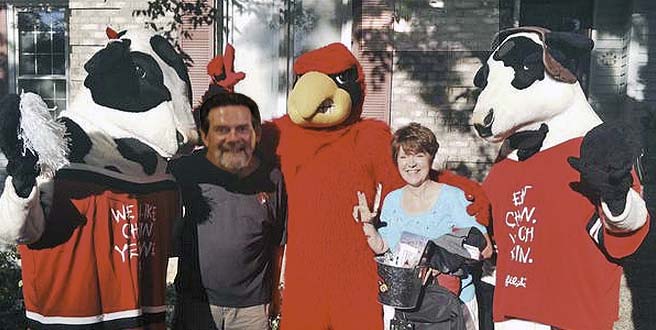 Long-time UofL fans Jerry and Yvonne Brumleve are joined by the Cardinal Bird and Chick-fil-A cows. 
